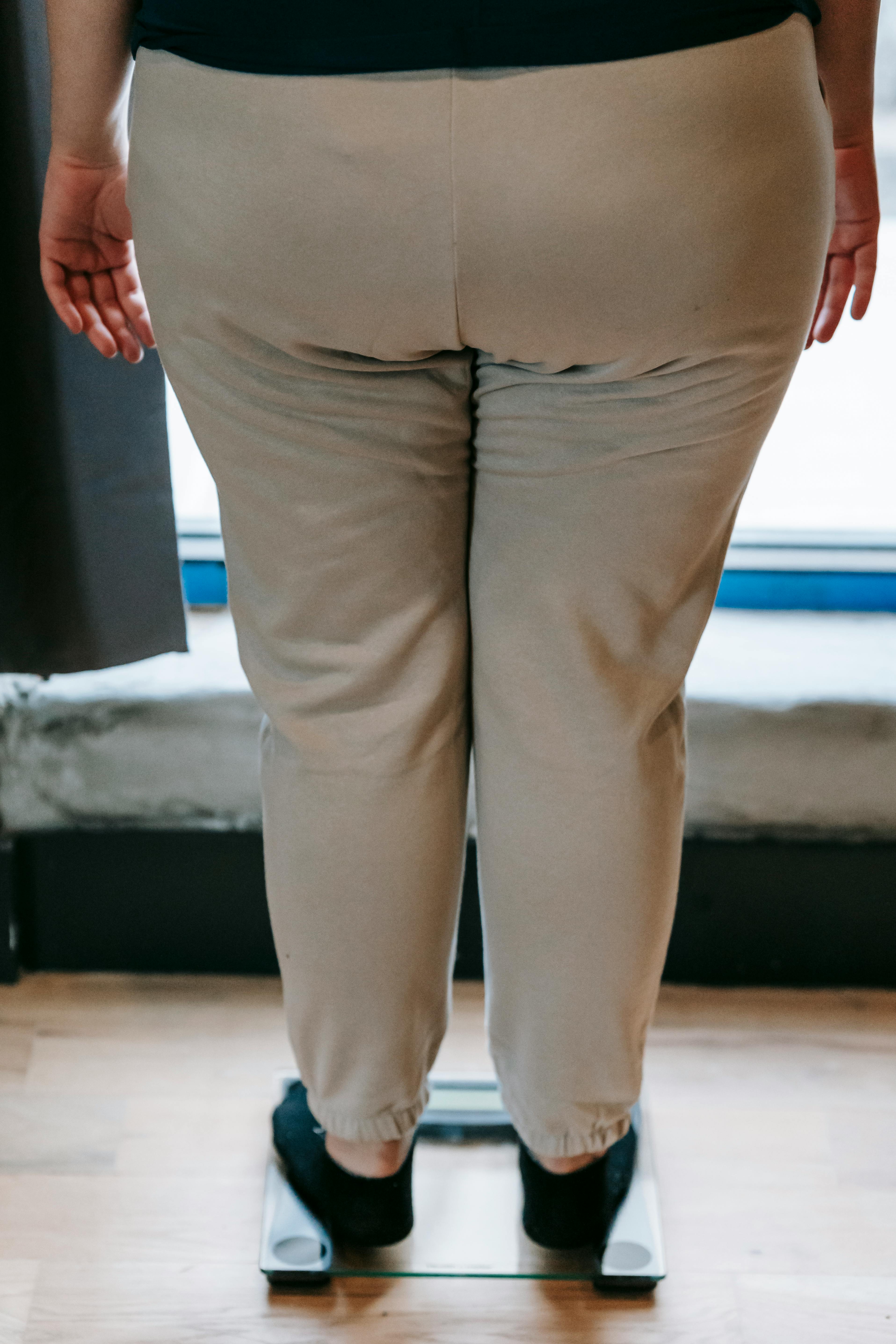 Woman who has gained weight in menopause stands on scale