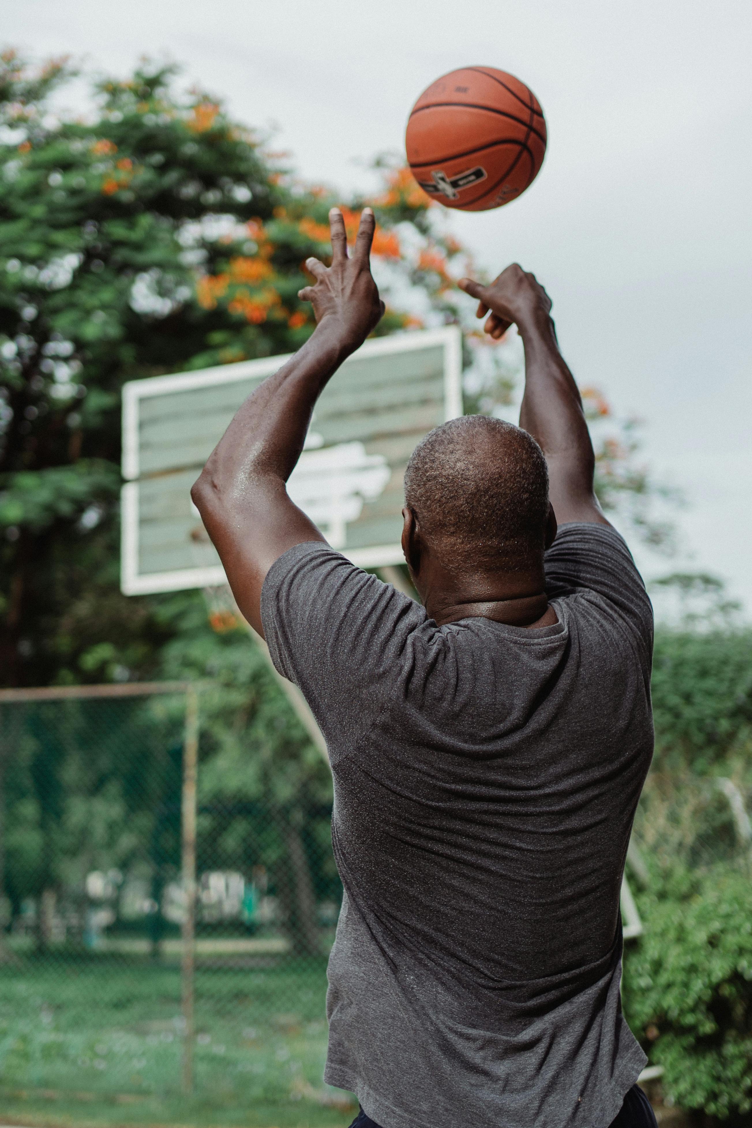 Older man shooting a basketball