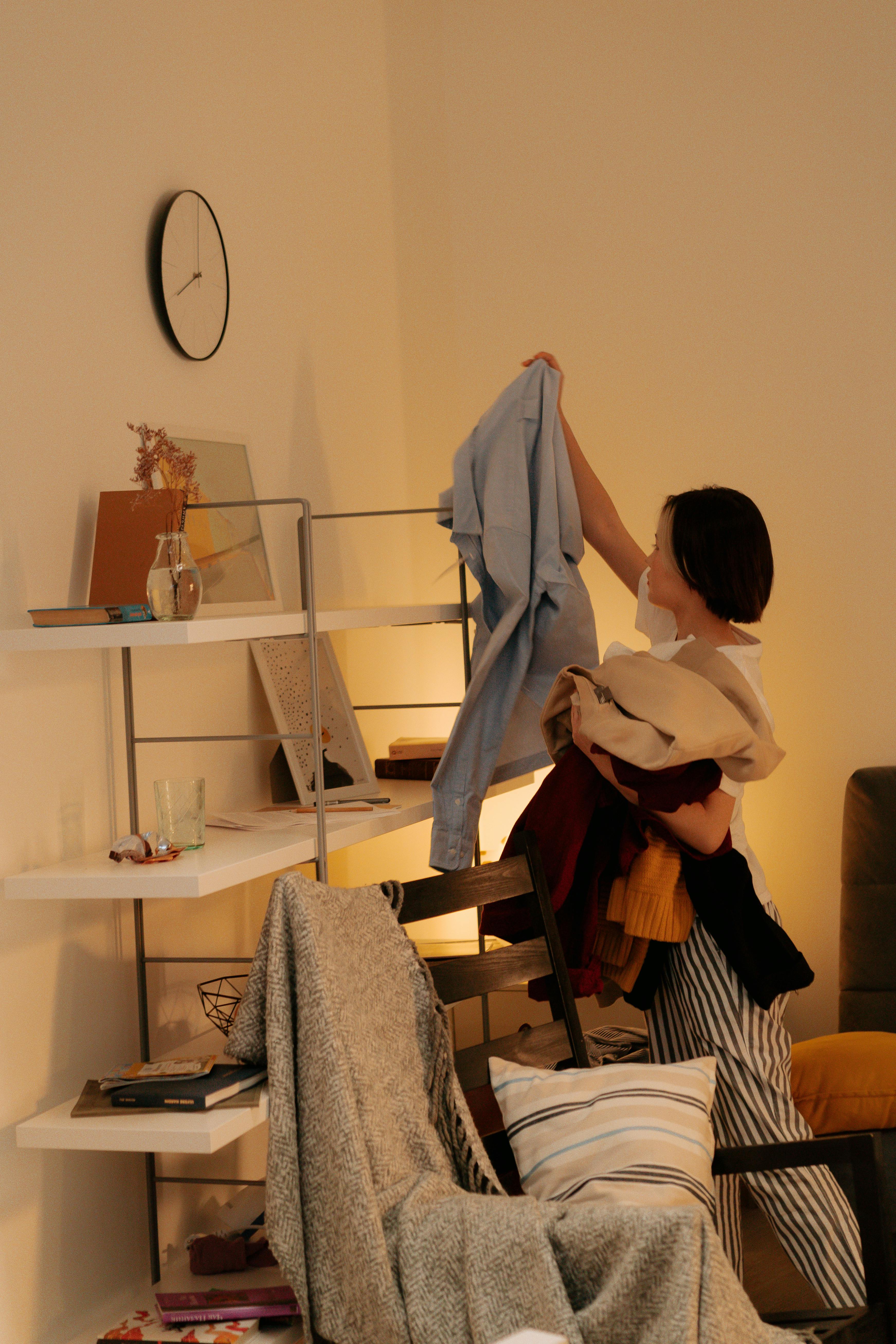 Woman clearing clutter from room