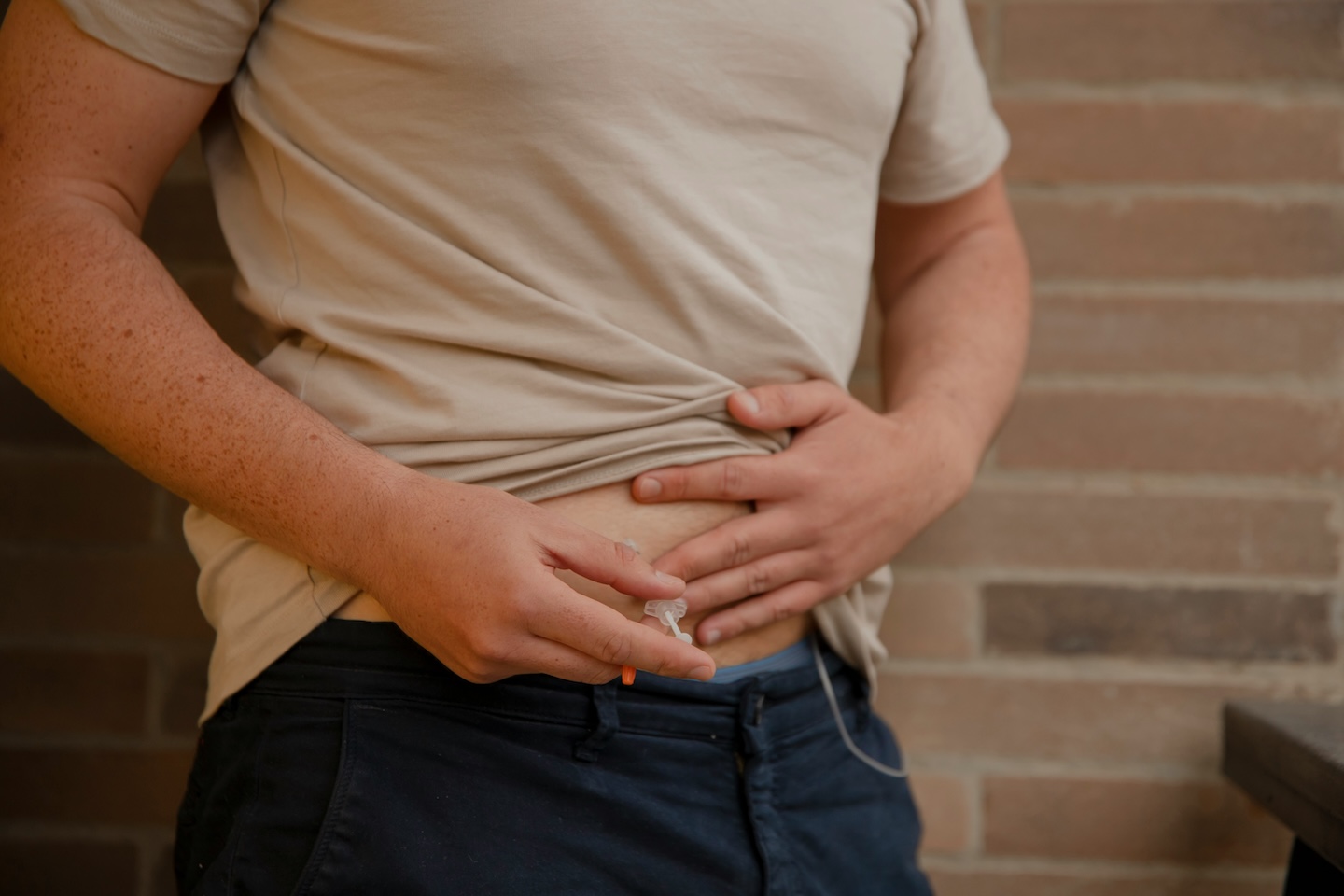 Man injecting GLP-1 medication into abdomen
