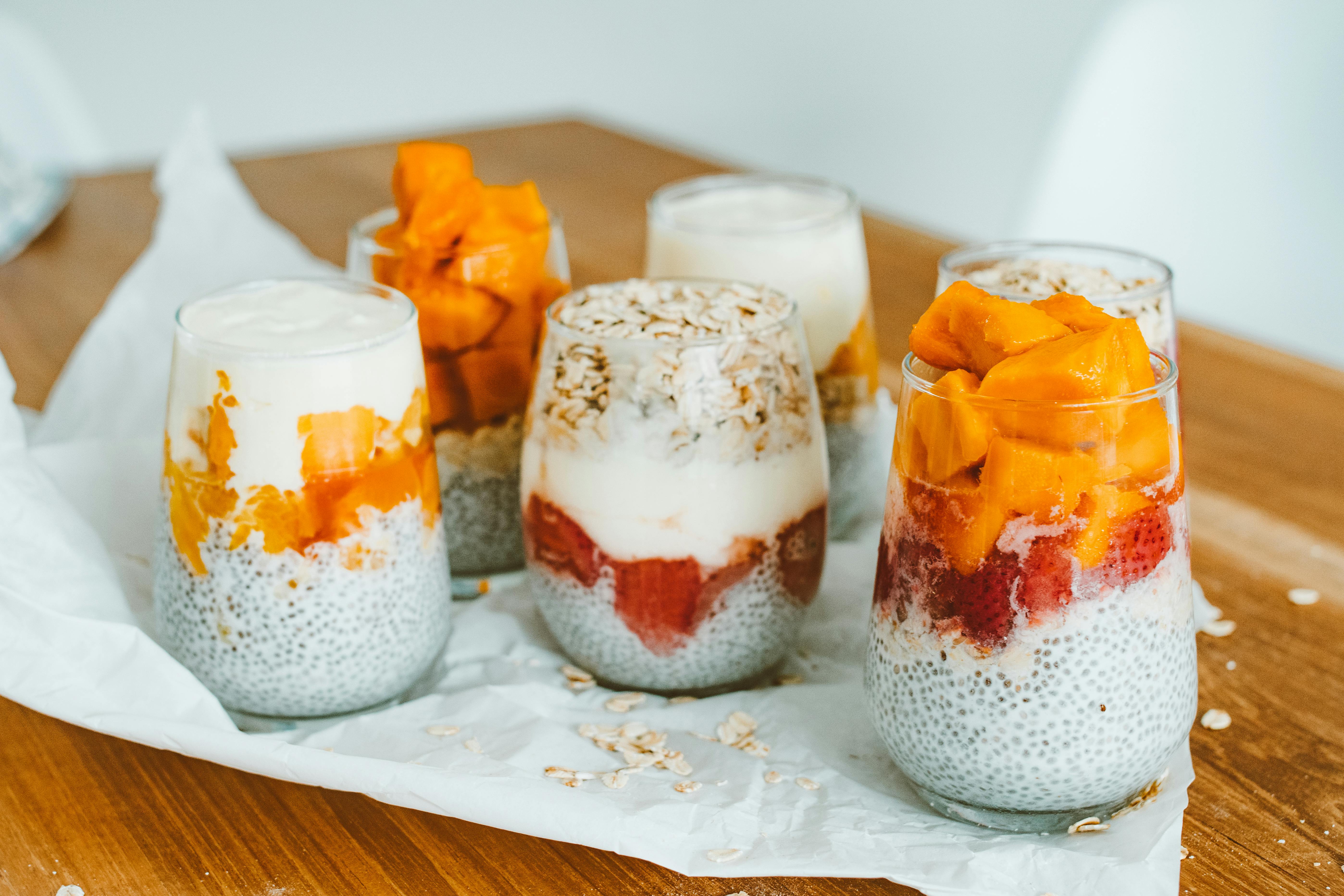 Jars of overnight oats with chia seeds, fruit, and oatmeal