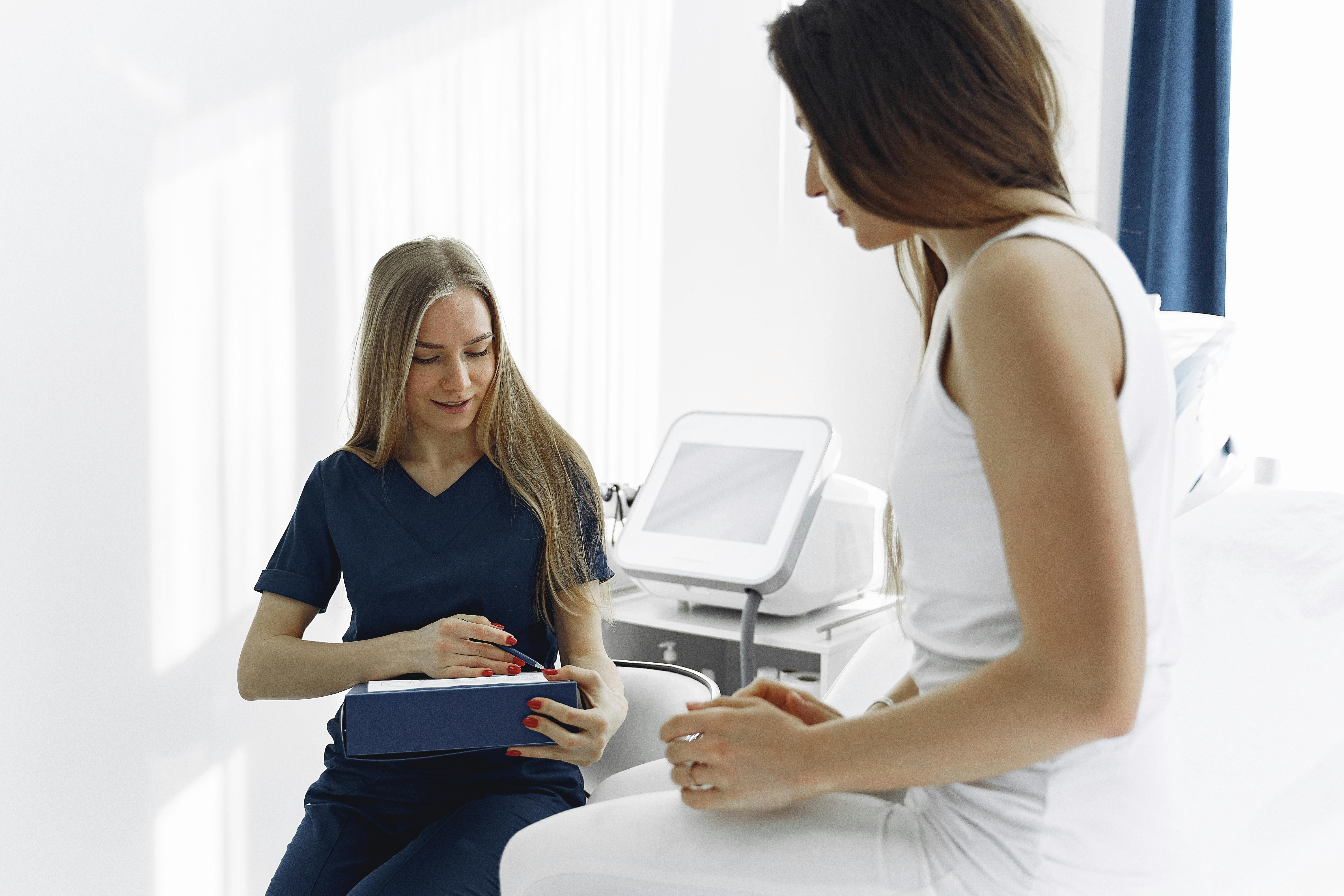 Woman at doctor's office talking to a nurse