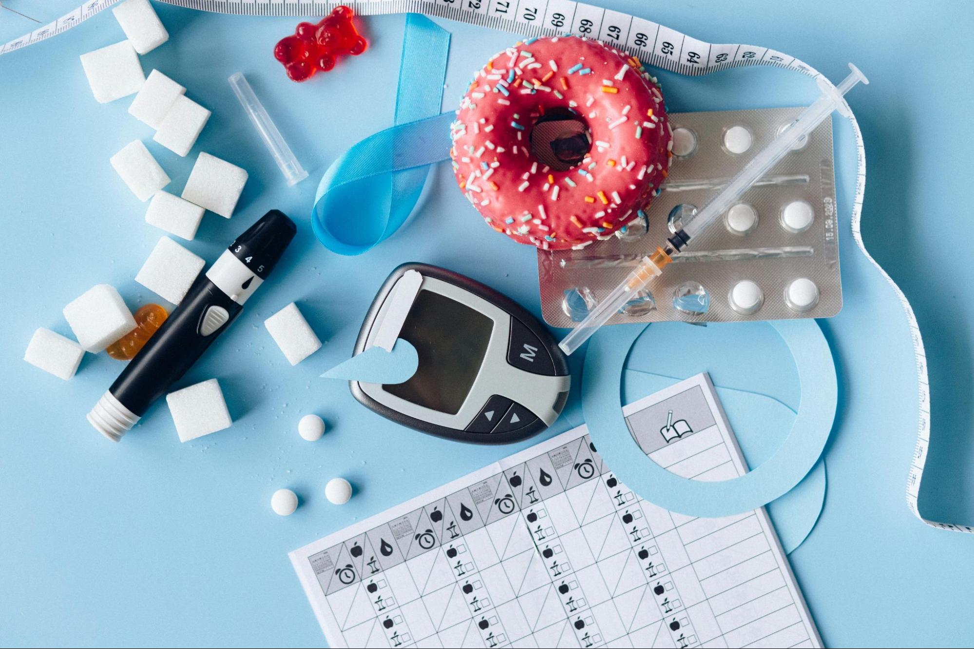 Diabetes and weight management tools laid out on a blue background.