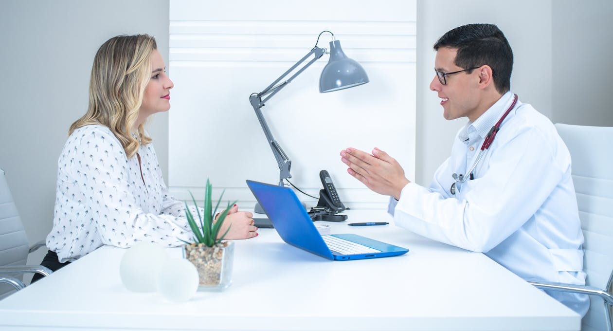 woman speaking with a doctor in office