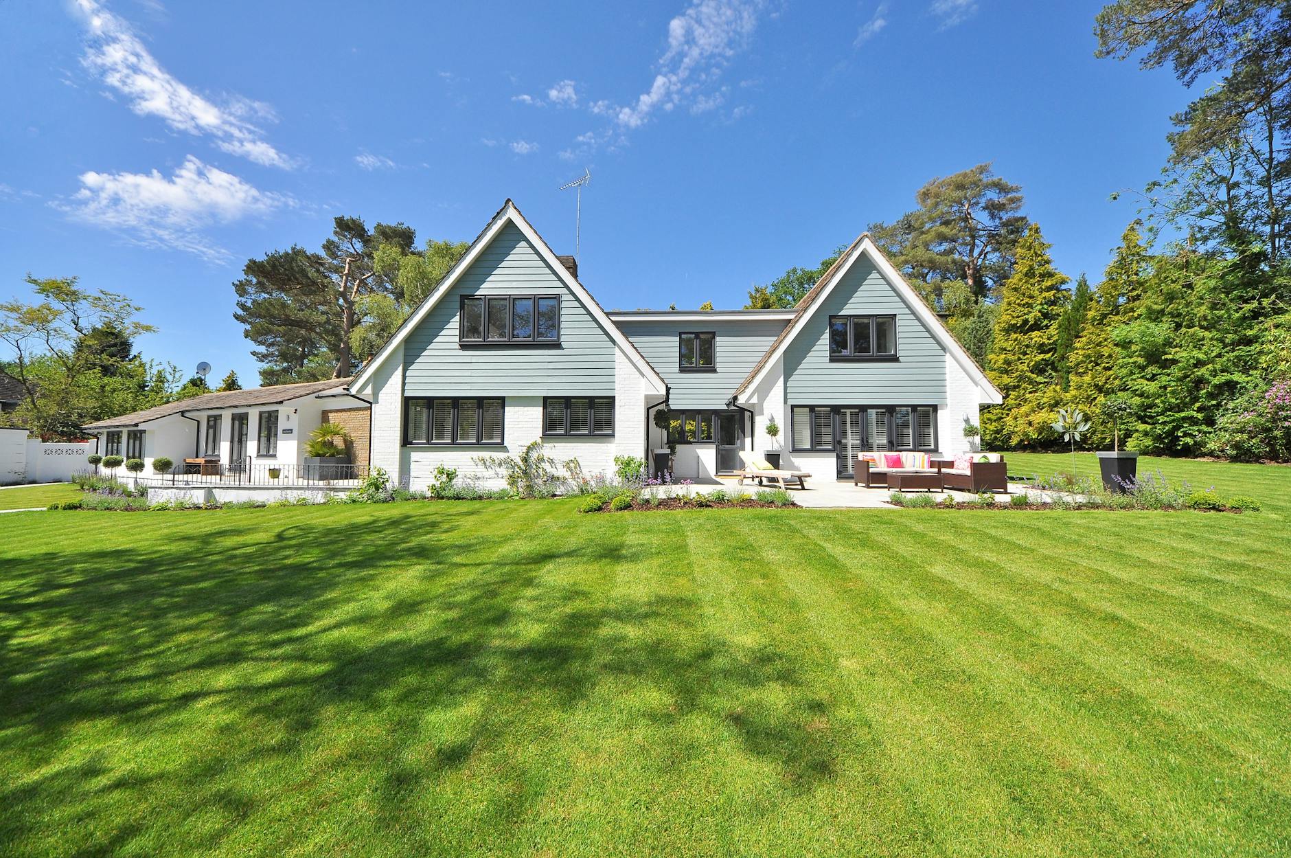Large residential backyard with a professionally maintained green lawn