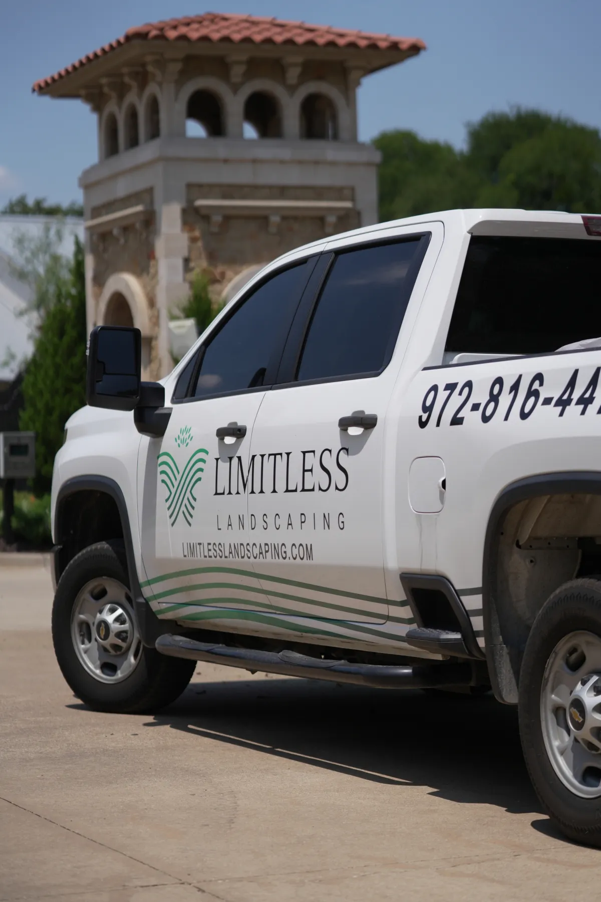 Limitless Landscaping service truck at a customer’s property