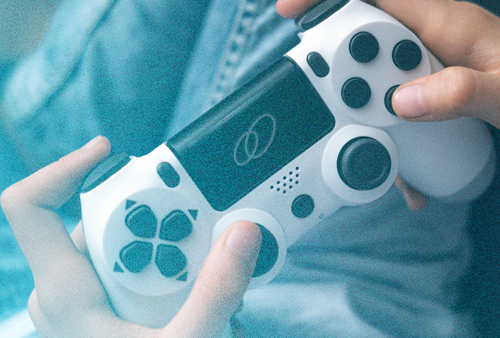 Person holding computer game controller with a ClearMotion logo on it