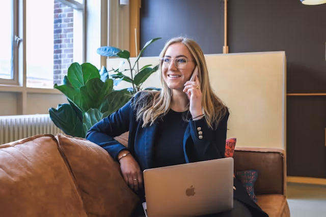 Business woman on a call sitting on a sofa