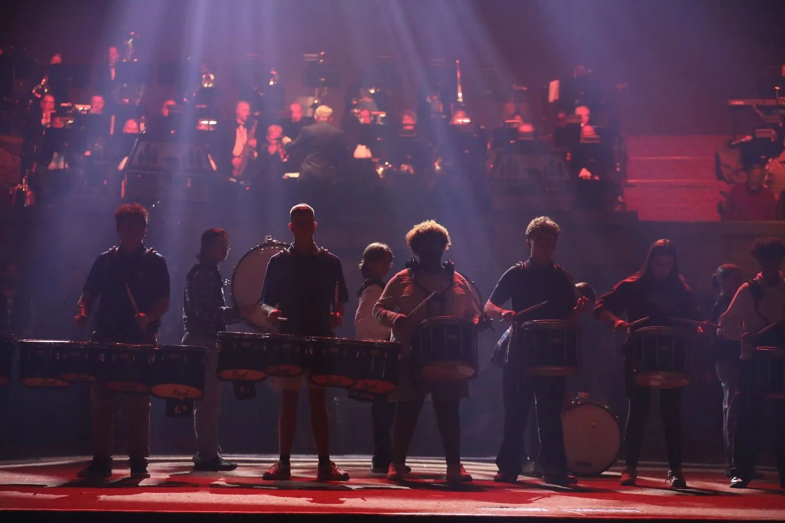 Drumline lit by beams of light