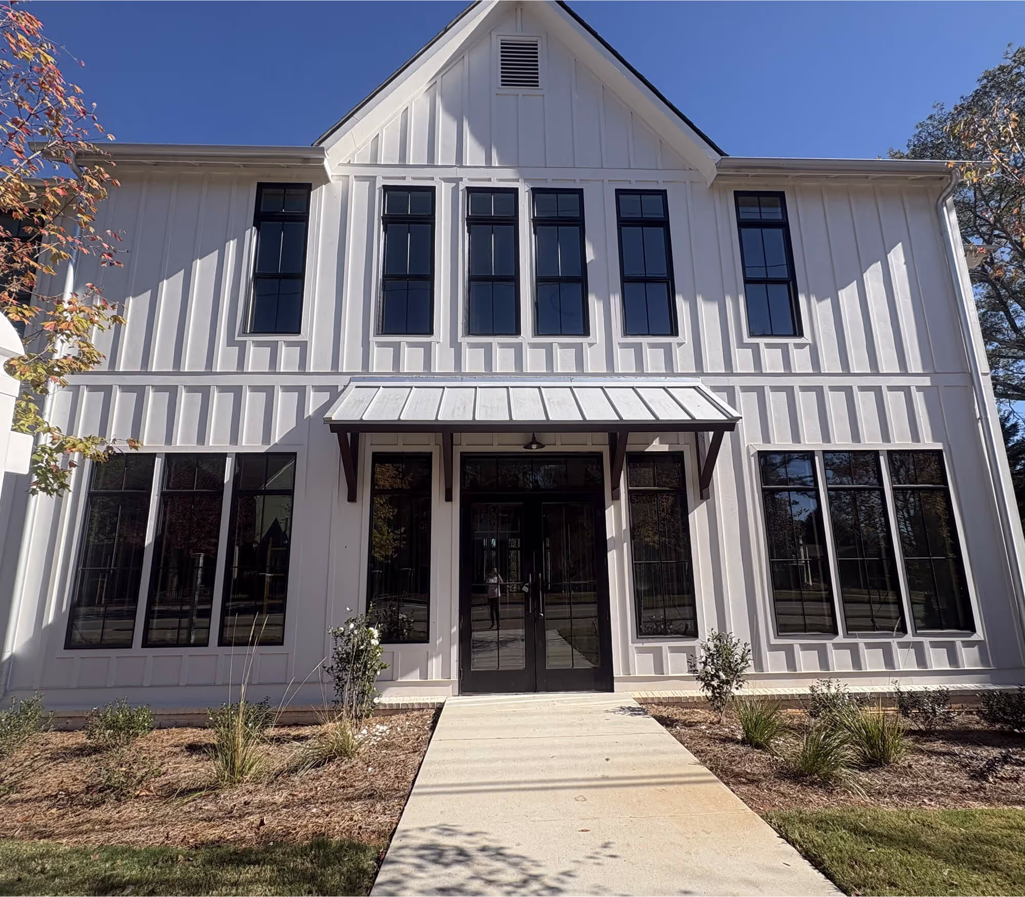 A large white house with a metal roof.