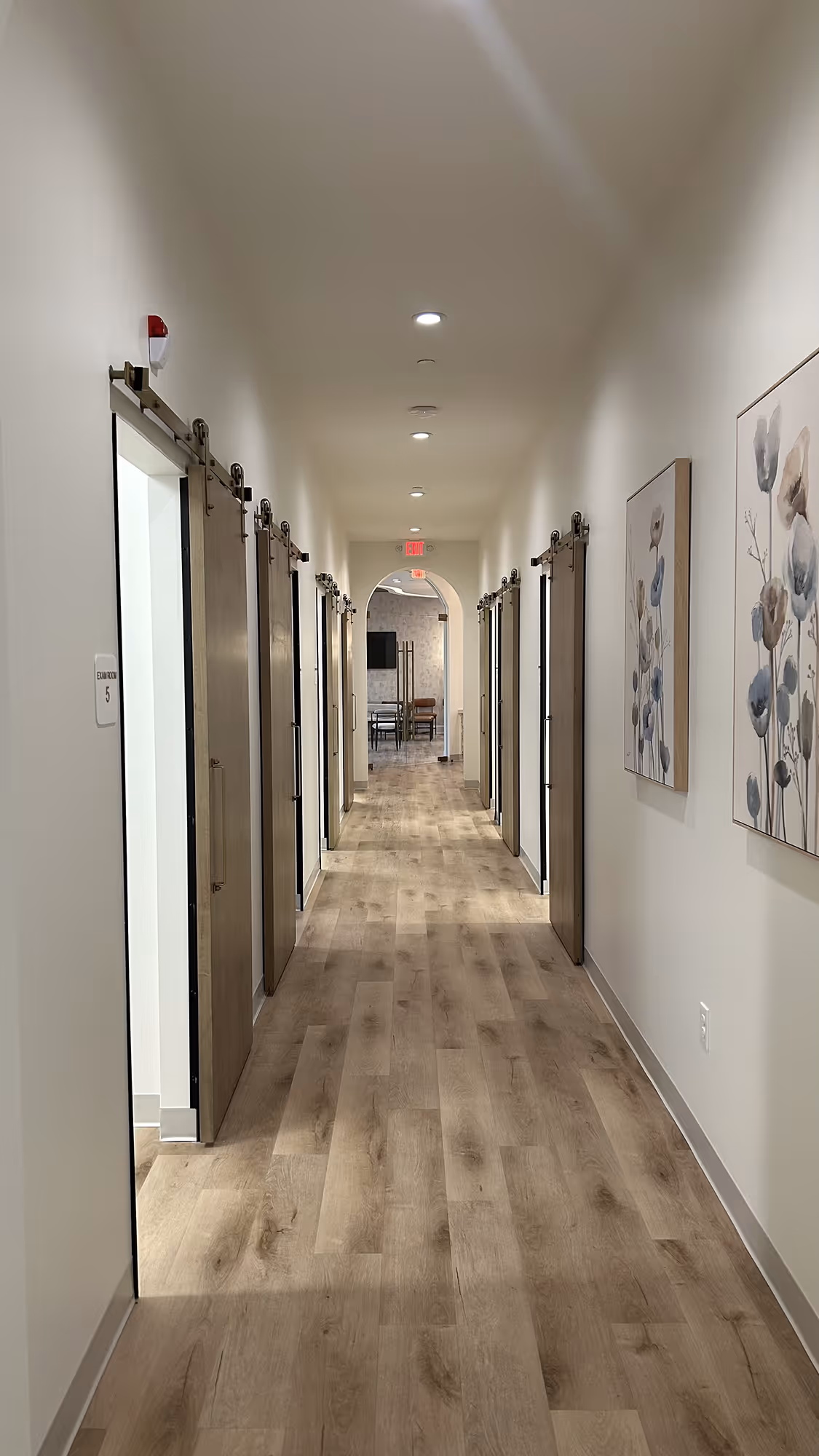 A long hallway with a bunch of doors.
