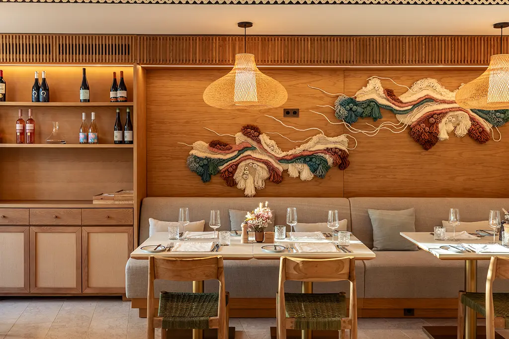 Elegant restaurant interior at Palácio de Tavira with warm wooden decor and refined dining setup