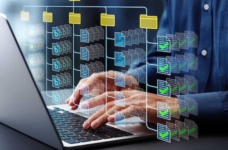 Hands typing on a laptop