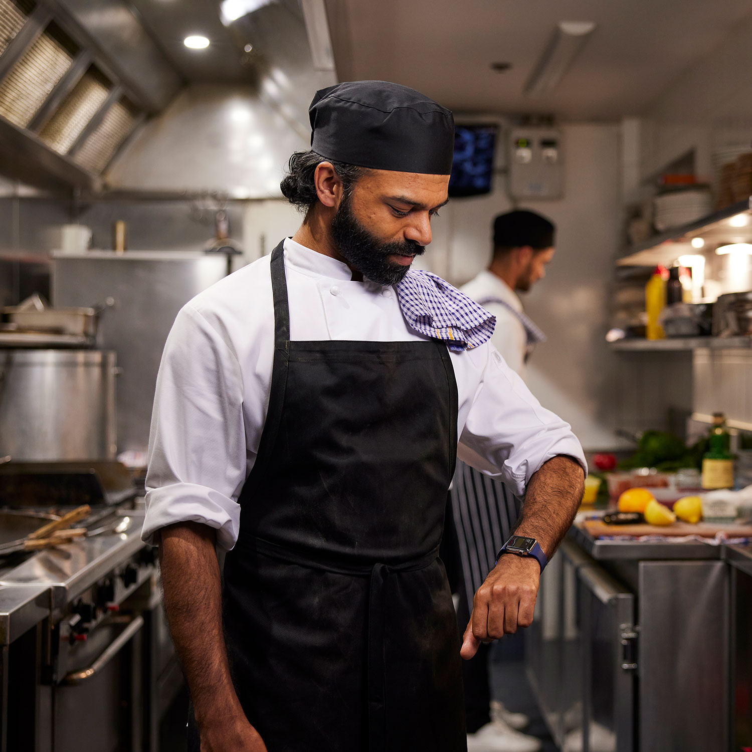 Male cook checks Dexcom stats on smartwatch