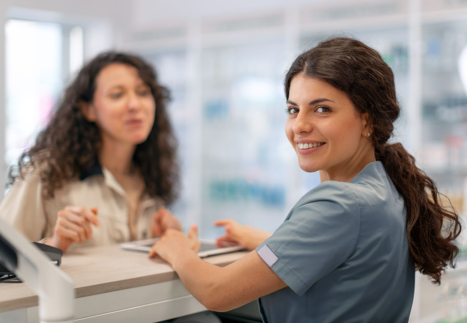 Smiling healthcare professional supporting a woman during an intake or counseling session at an alcohol treatment program