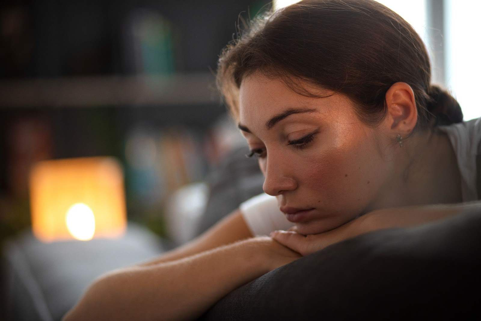 Young woman resting her chin on her hands, reflecting on the challenges of alcohol addiction and the hope of recovery through treatment programs