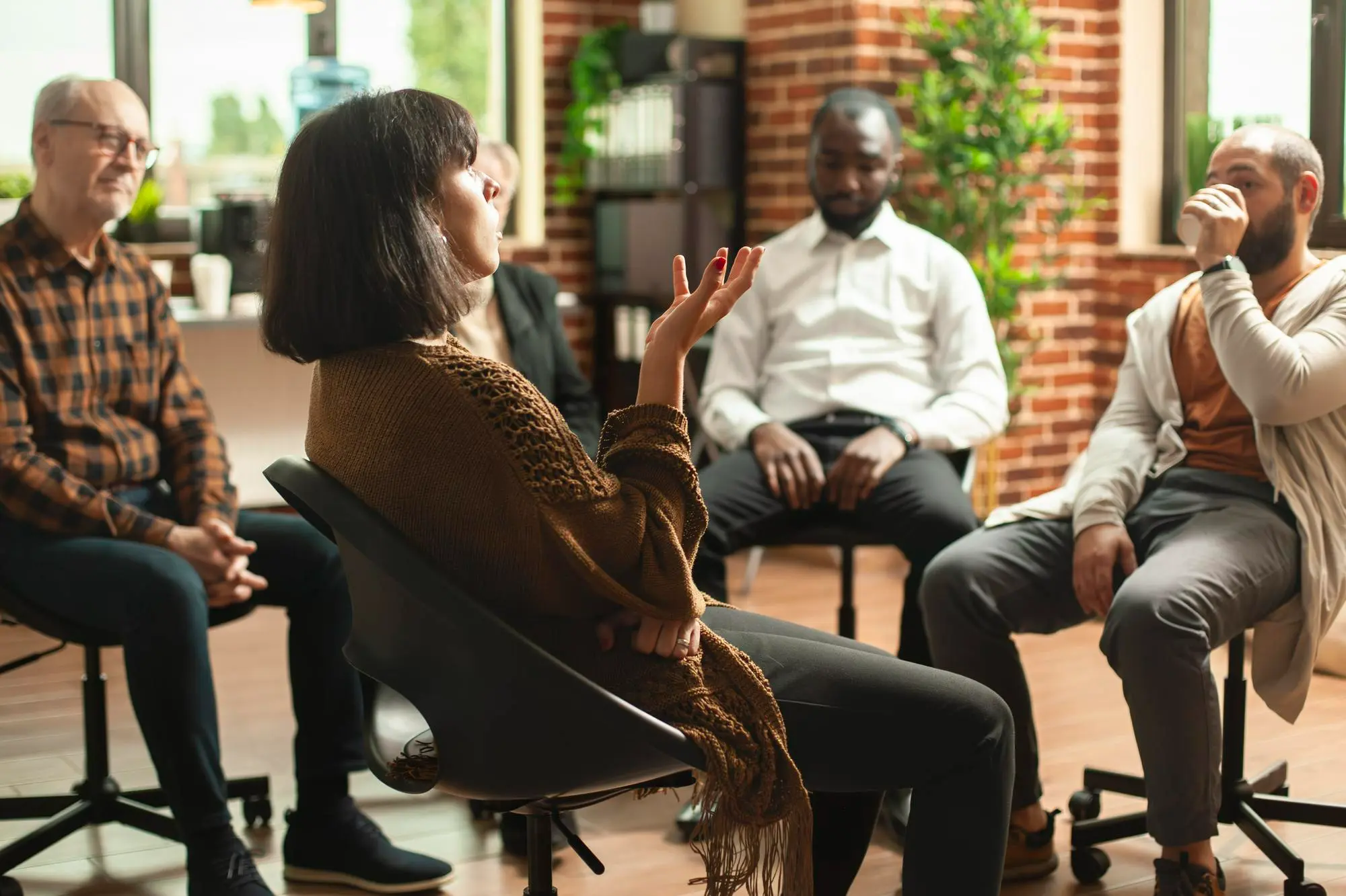 A participant sharing their experience during a peer-led recovery support meeting