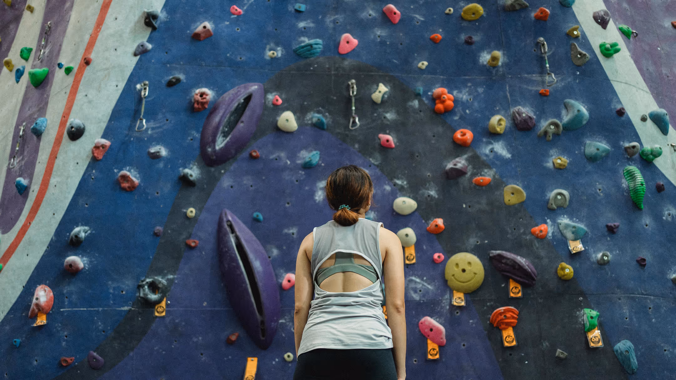 Rock climber looking up at wall