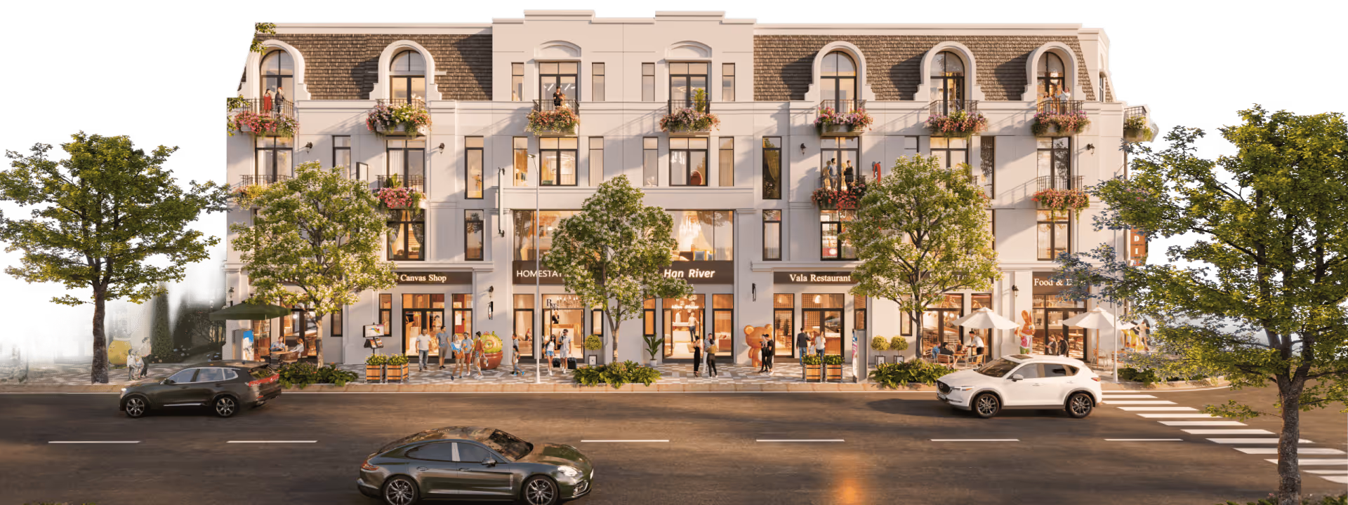 Modern white three-story building with shops on the ground floor, people walking on sidewalks, balconies with flower pots, and cars driving on a street lined with trees.