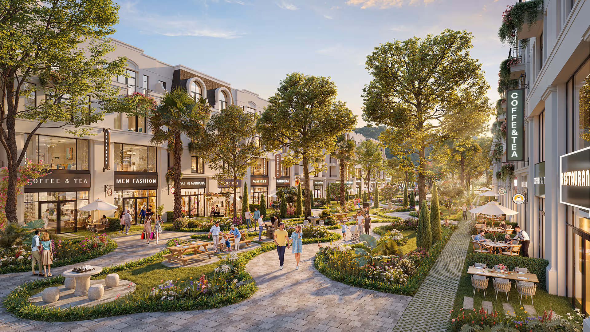 Tree-lined pedestrian shopping street with people walking and sitting at outdoor cafes and benches in a landscaped urban area.