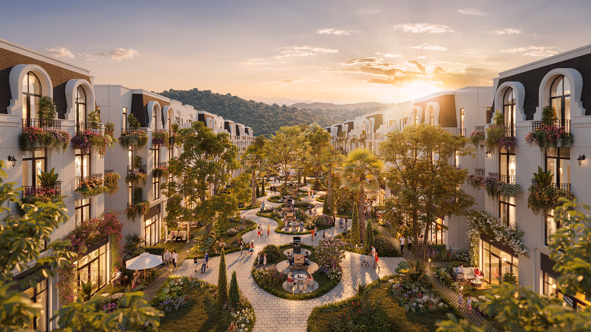 Sunset view of a landscaped pedestrian walkway with trees, flowering plants, benches, and people walking between modern multi-story residential buildings.