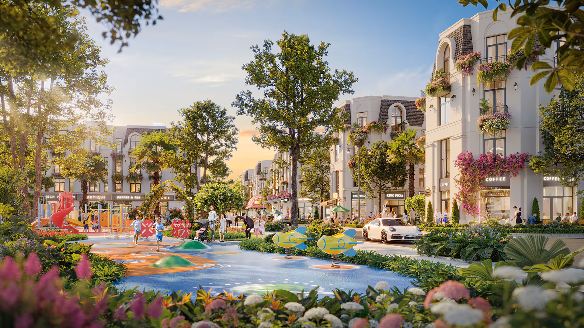 Playful urban park with children playing near water features and flower-filled landscaping, surrounded by multi-story buildings with cafes and shops.
