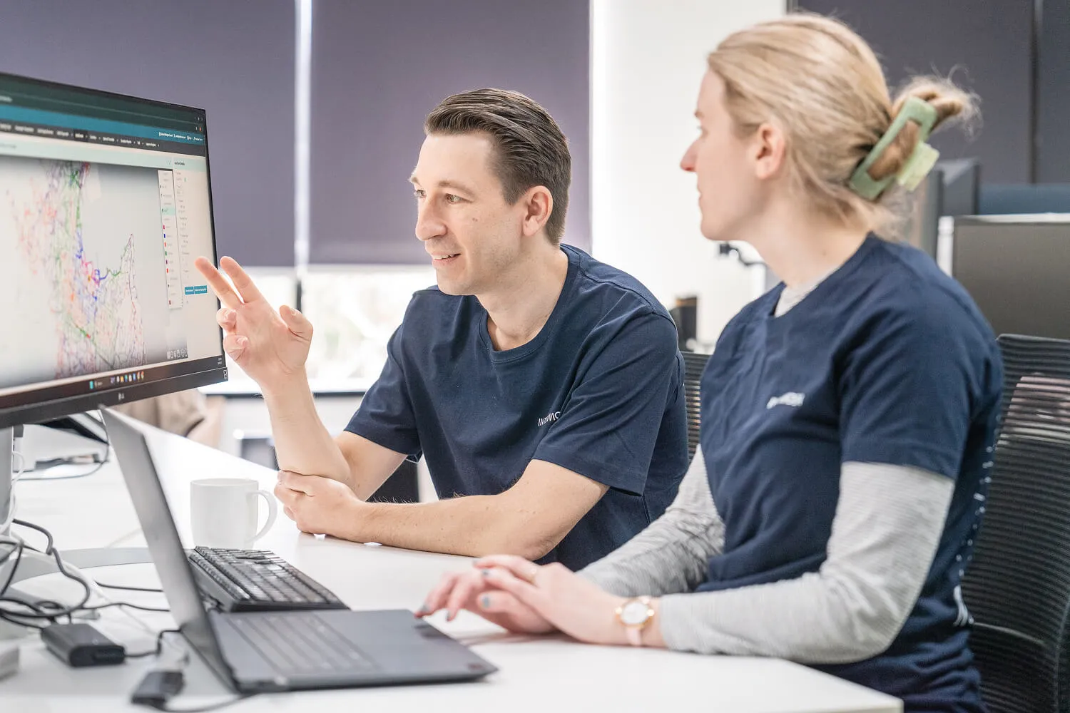 Two Intermoda team members reviewing network data visualisation on screen
