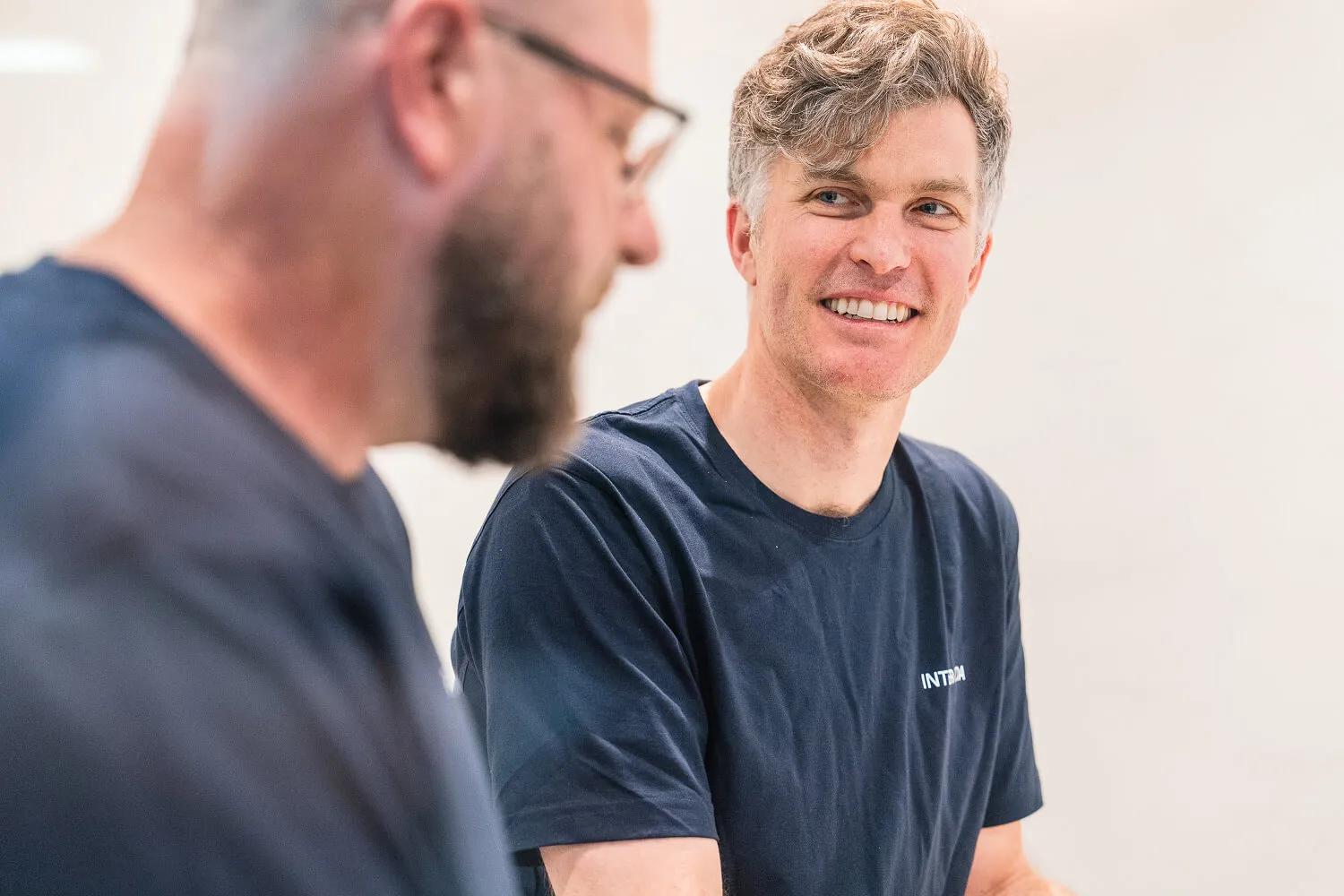 Two Intermoda team members talking and smiling during a meeting
