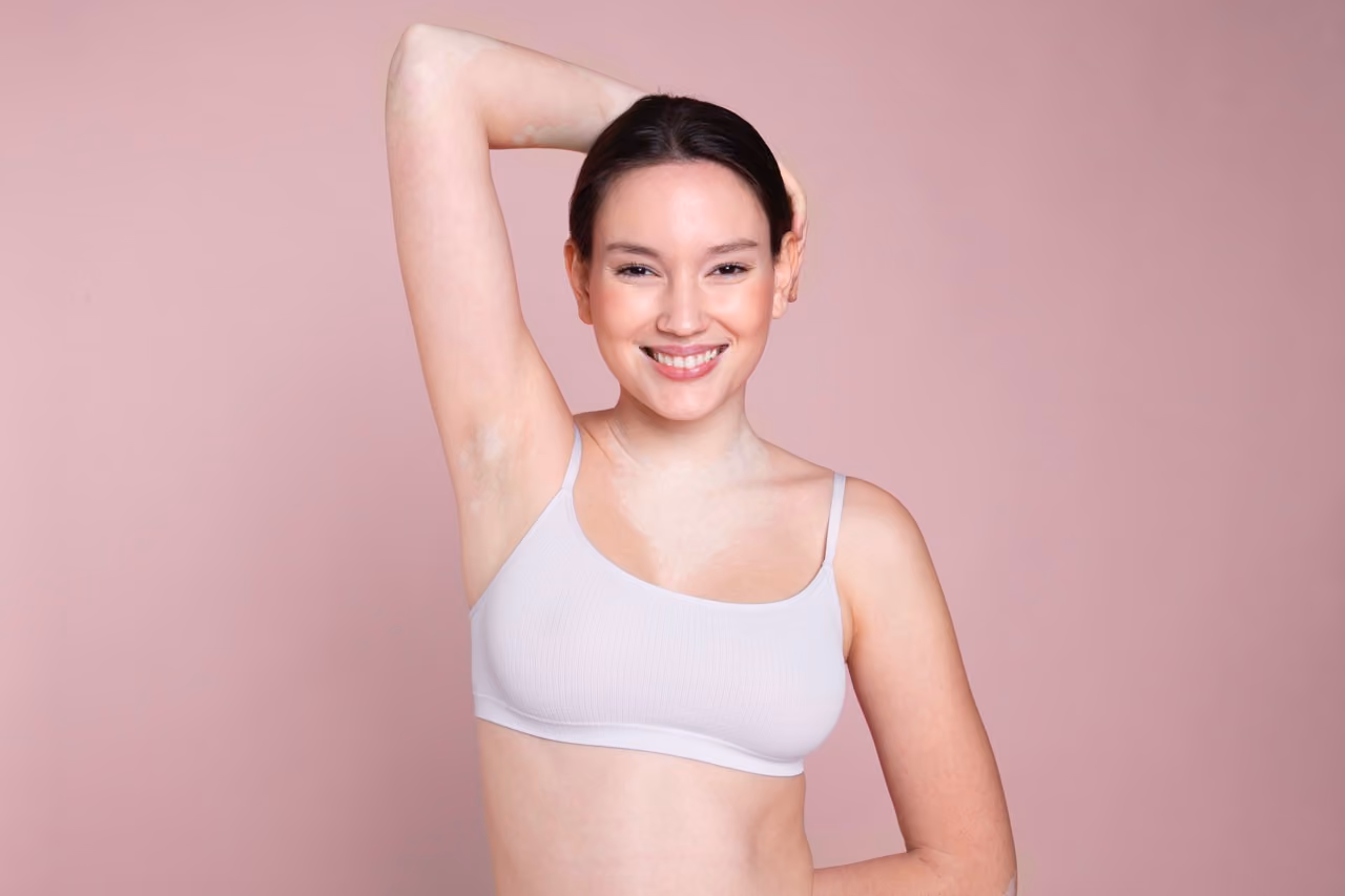 Smiley woman portrait showing smooth waxed underarm, beauty and grooming