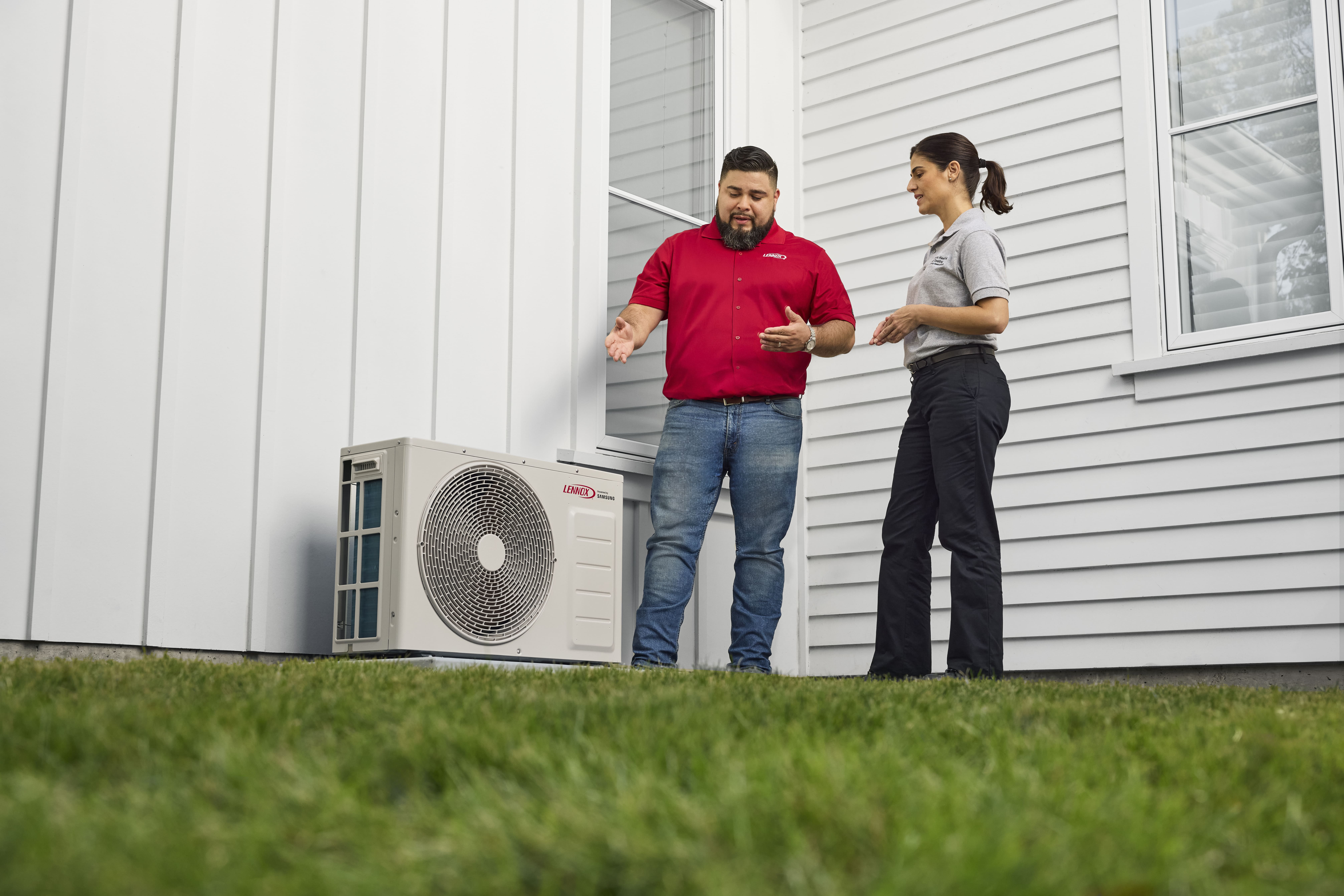 Modern heat pump installed outside home with sunny garden backdrop