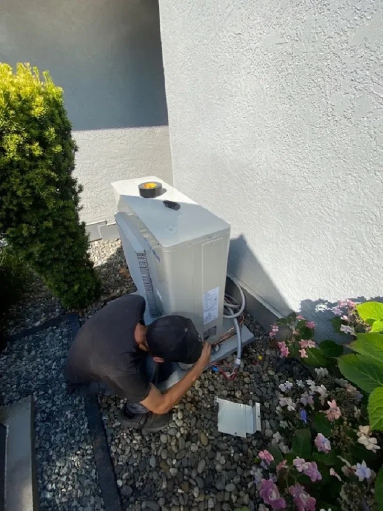 Technician performing HVAC maintenance, showcasing best practices for energy efficiency