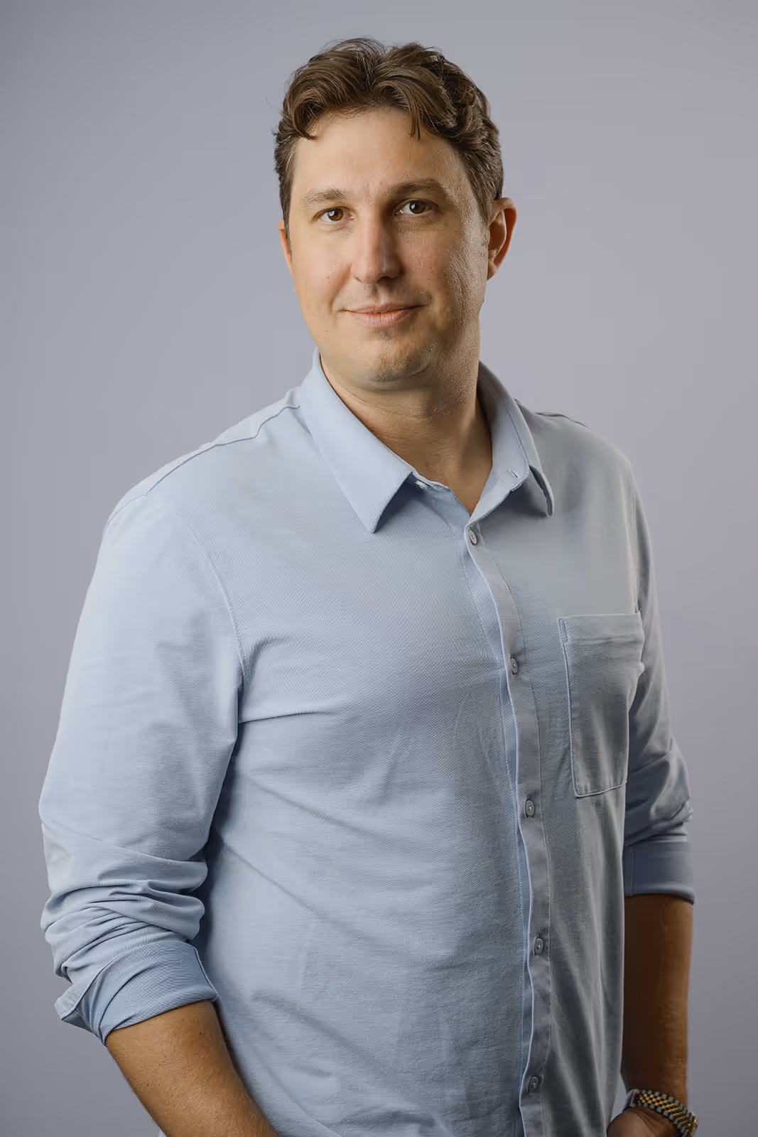 Profile image of managing partner, in suite, smiling