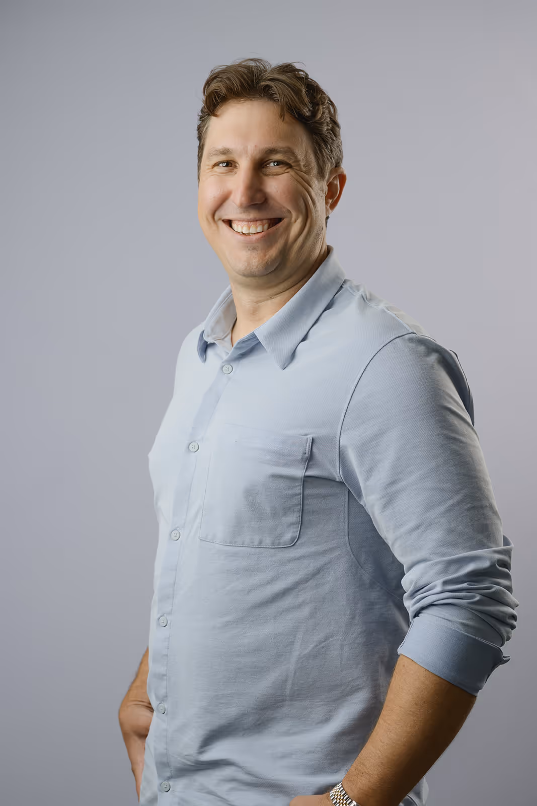 Profile image of managing partner, in suite, smiling