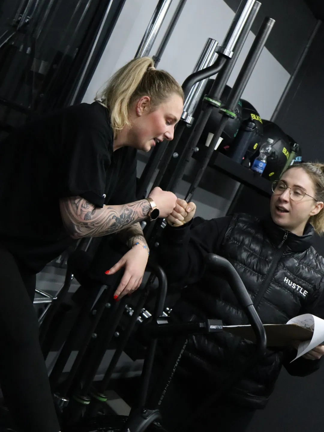 A HUSTLE personal trainer fist pumping a member after a workout