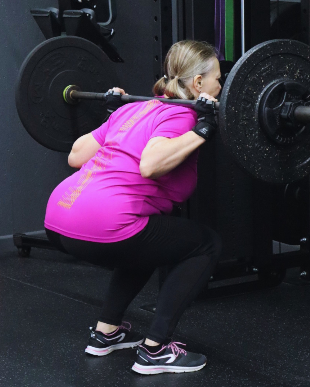 A HUSTLE personal trainer fist pumping a member after a workout