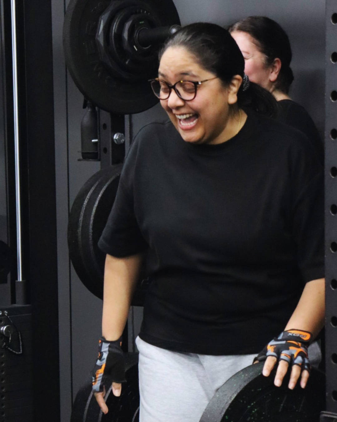 A HUSTLE personal trainer fist pumping a member after a workout