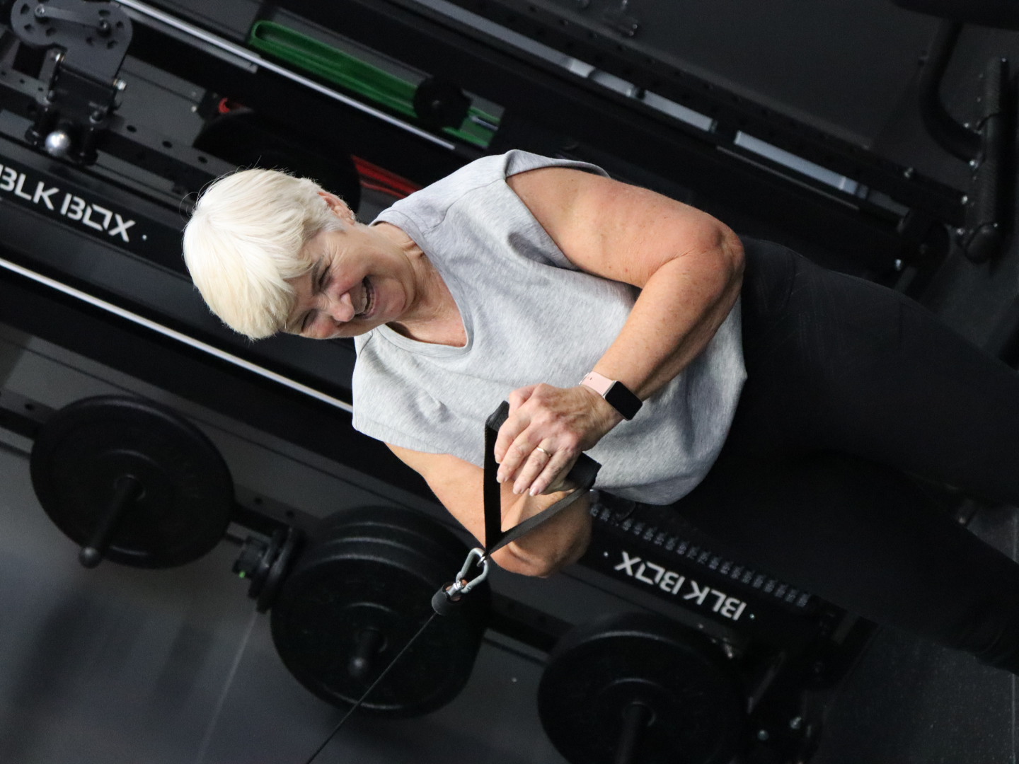 A HUSTLE personal trainer fist pumping a member after a workout
