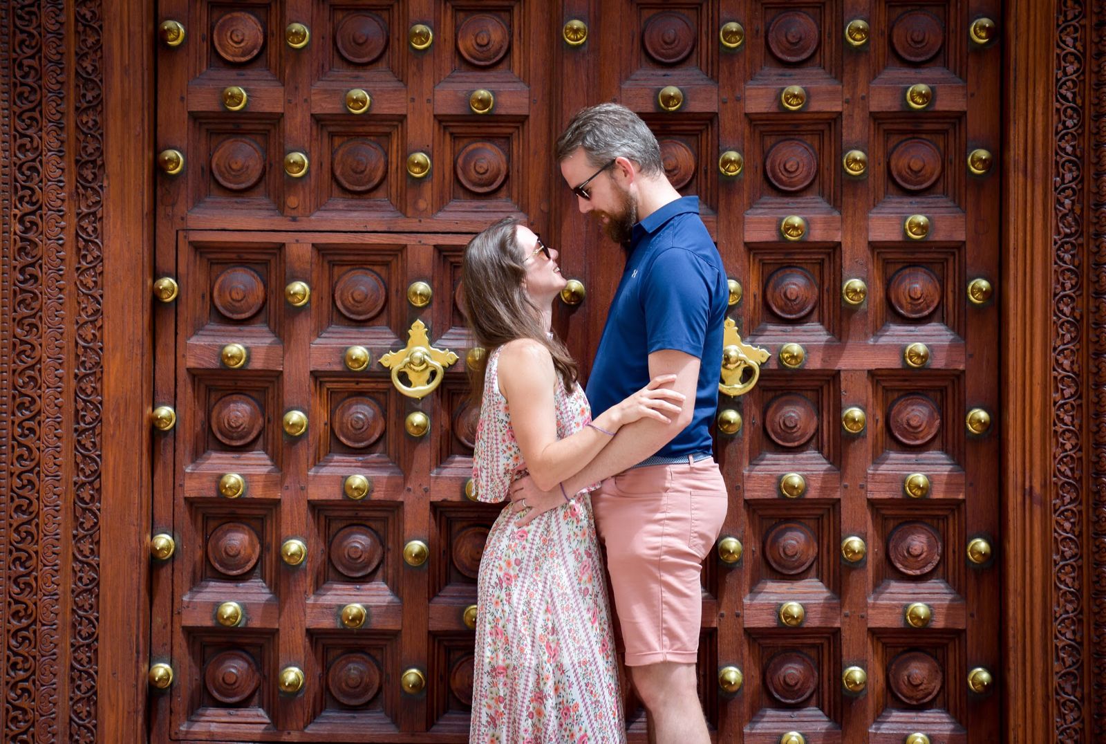 Tourist Couple behing an artistic carved Zanzibarian door