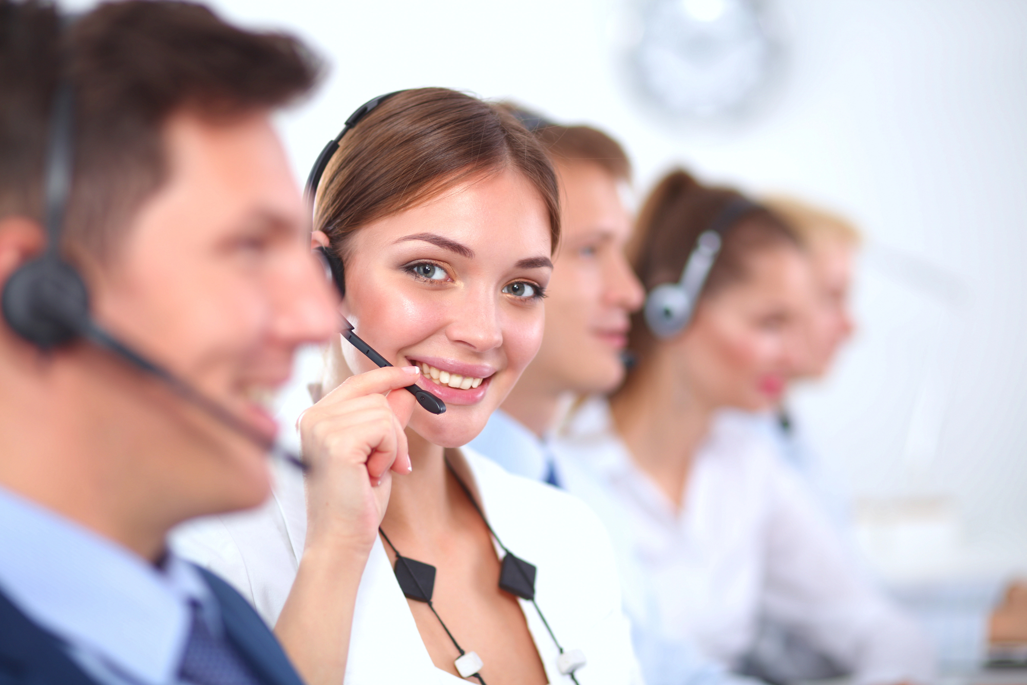 people and woman with headset providing call handling services