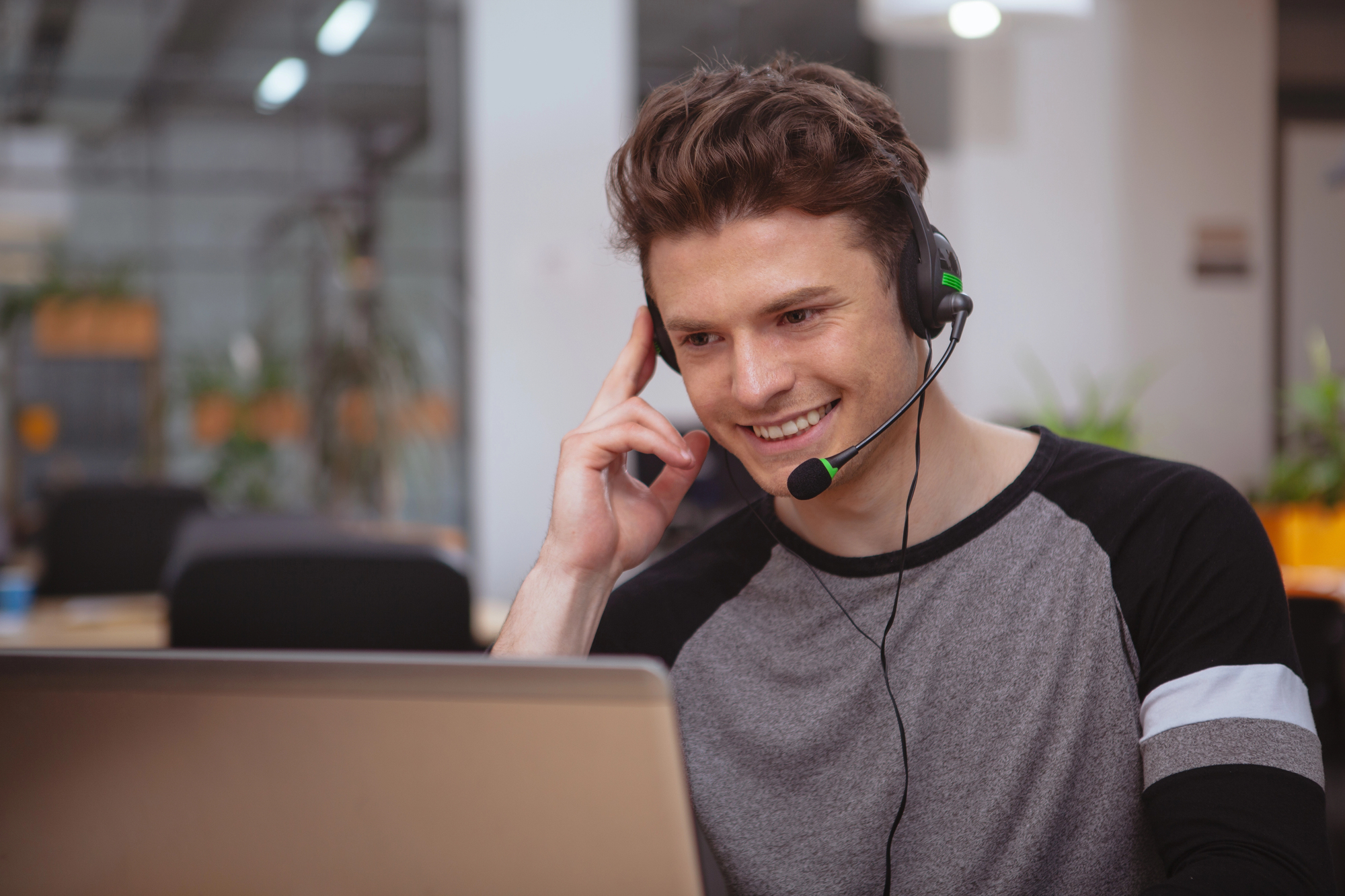 man smiling while providing overflow phone answering service