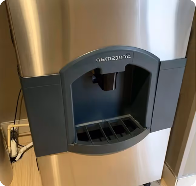 Stainless steel Scotsman ice maker mounted on wall with open door