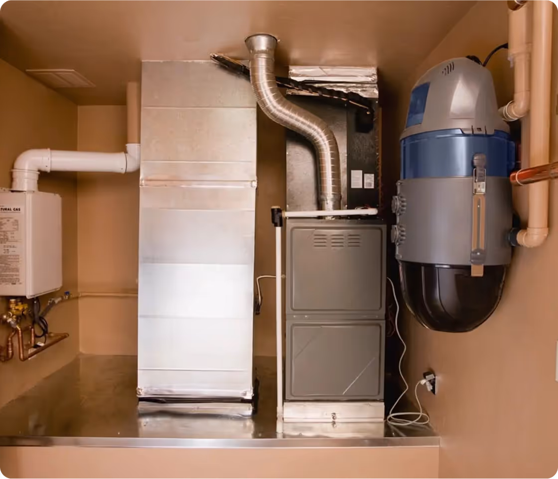 Utility room with water heater, furnace, and air conditioning unit