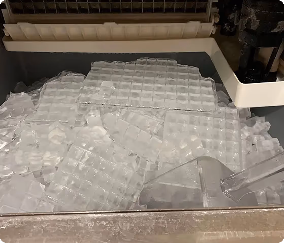 Ice cubes from an automatic ice maker scattered on kitchen counter