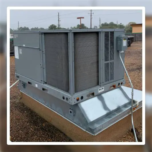Large industrial HVAC unit installed on concrete pad with utility poles