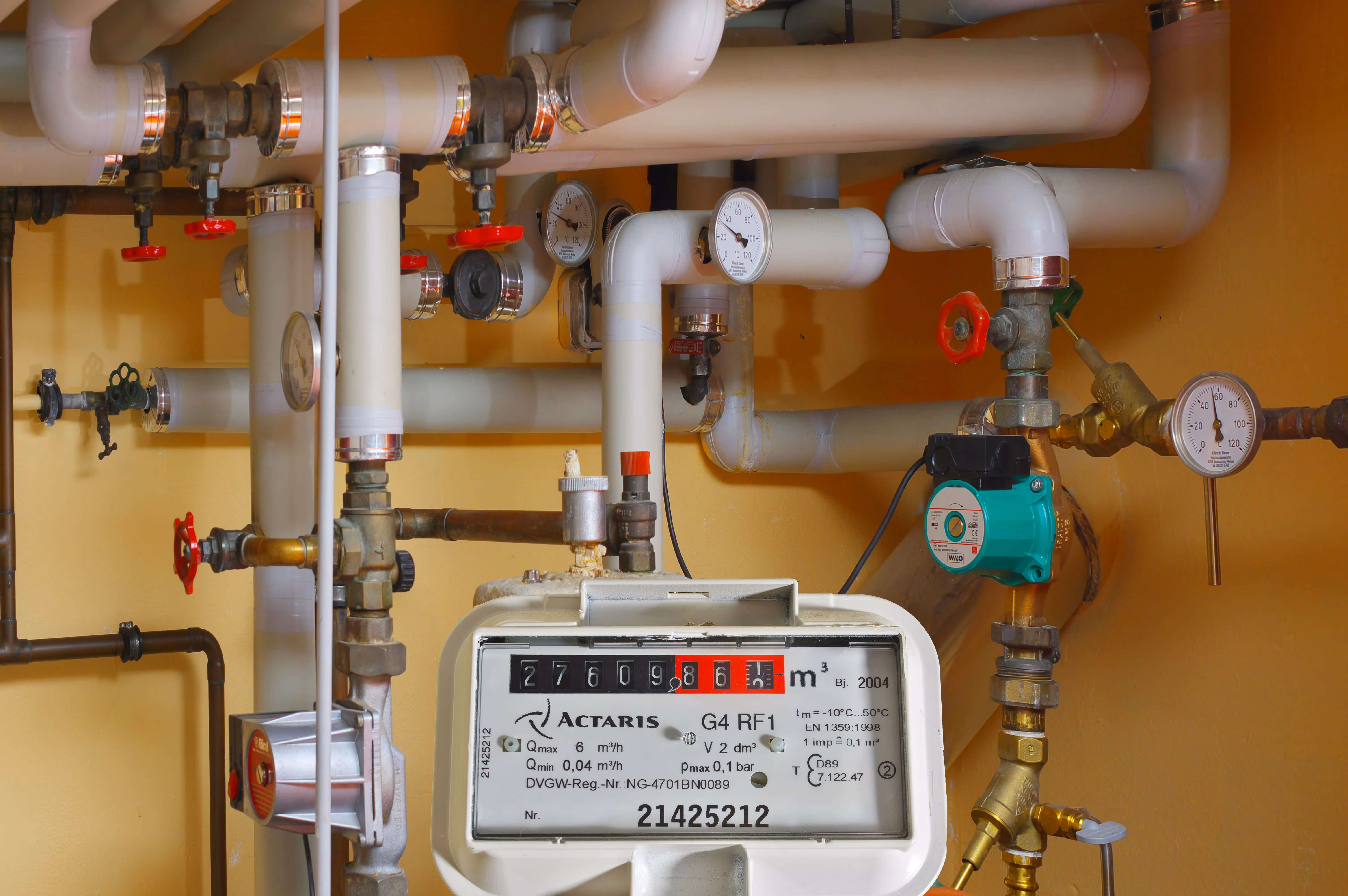 Complex plumbing system with pipes, valves, gauges, and a gas meter