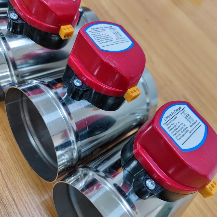 Red-capped metal valves or pipe connectors on wooden surface