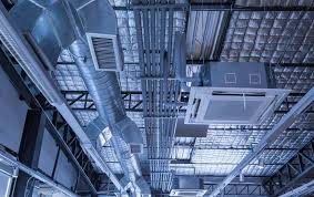 Industrial ceiling with complex network of metallic HVAC ducts and pipes