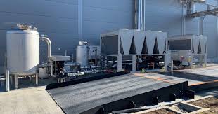 Industrial machinery and cooling units on a concrete platform in a factory