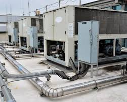 Industrial HVAC cooling units and ductwork on a flat roof