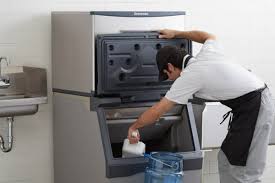 Chef preparing food in commercial kitchen refrigerator and freezer unit